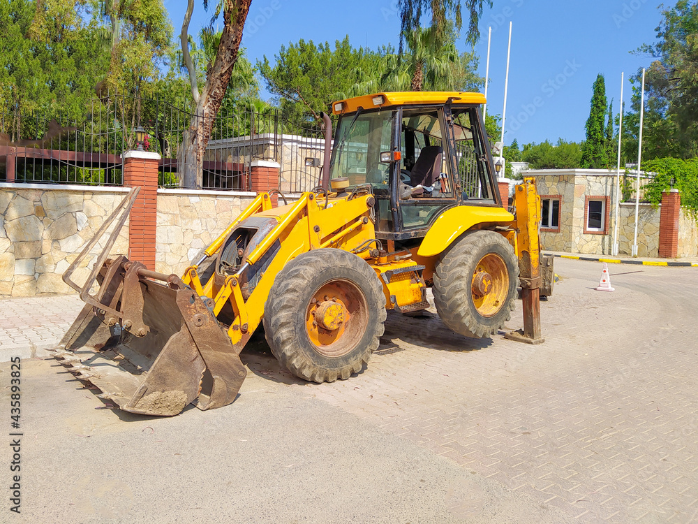Mini bulldozer or excavation or loader on road.