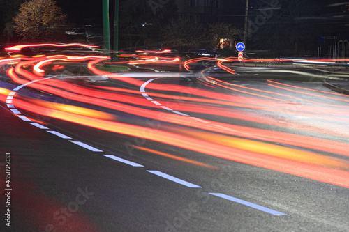 The junction of two roads, light traces from the car. The picture was taken at night at a slow shutter speed