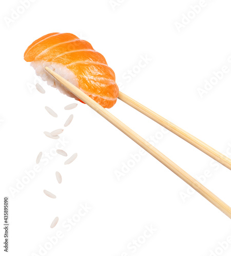 Fresh traditional japanese sushi with salmon between chopsticks, isolated on white background