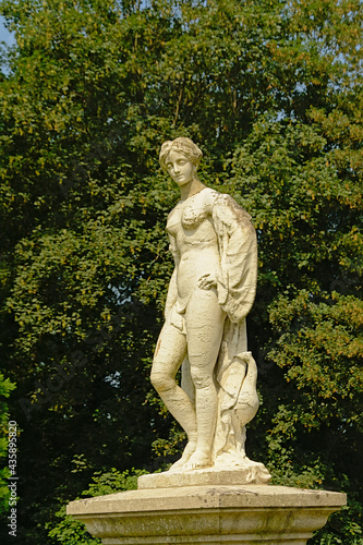  Stone statue of a young noble man in the French formal gardens of the castle of Chantilly, Oise, France 