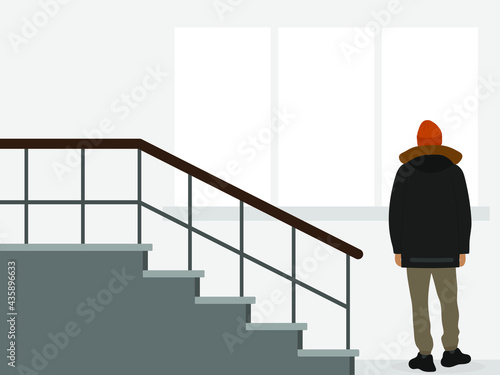 Male character in a jacket and hat stands on the staircase and looks out the window