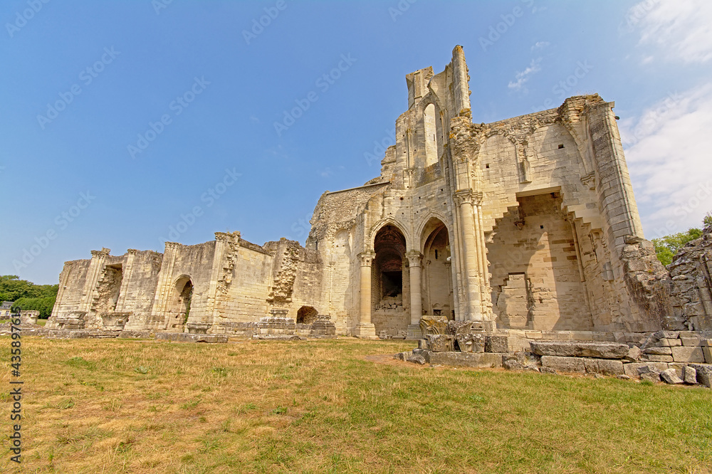 ruins of the medieval Abbey of Chaalis, Ermenonville, France, on a sunny day with clear blue sky
