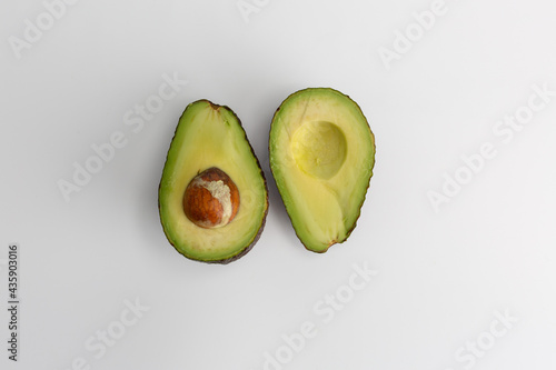 the avocado is cut in half and folded into a ying-yang shape