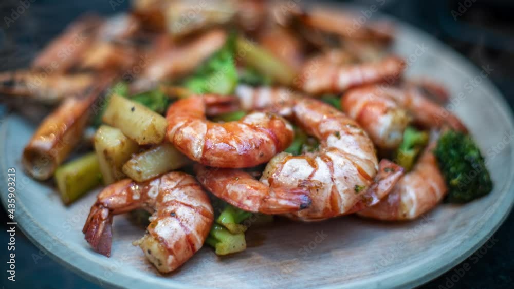 plate of shrimp and broccolis over the table plate of shrimp and broccolis over the table