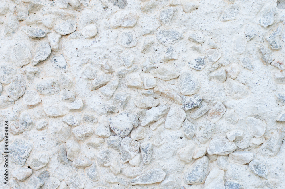 White wall with white and gray stones, texture, background White wall with white and gray stones, texture, background