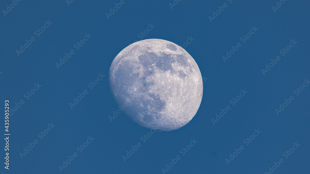 Closeup of waxing gibbous moon during daytime against clear blus sky - Stuttgart, Germany May 23, 2021 Closeup of waxing gibbous moon during daytime against clear blus sky - Stuttgart, Germany May 23, 2021