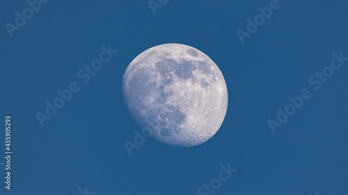 Closeup of waxing gibbous moon during daytime against clear blus sky - Stuttgart, Germany May 23, 2021