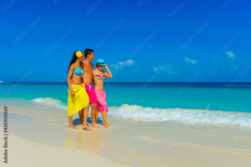 Young people at the beach playing, walking on the beach, interracial, black