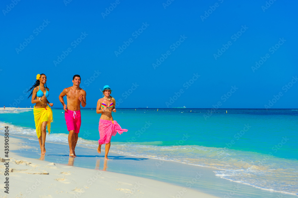 Young people at the beach playing, running on the beach, interracial, black