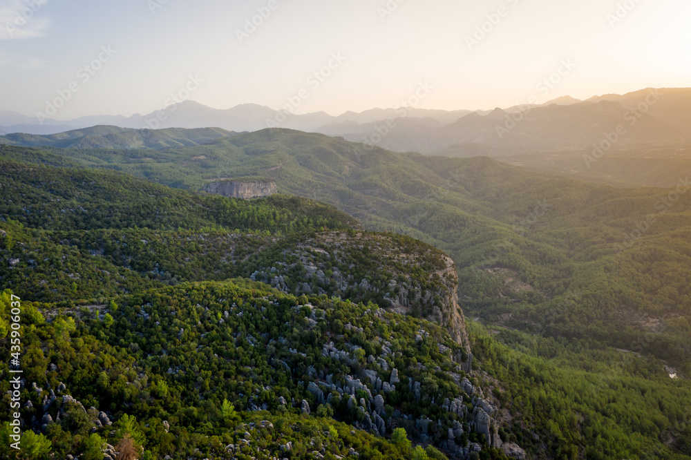 Naklejka premium Morning landscape just after sunrise. The sun's rays fall on the mountain valley. Aerial view of Canyonlands National Park near ancient city of Selge Adam Kayalar, Turkey. Koprulu Canyon.