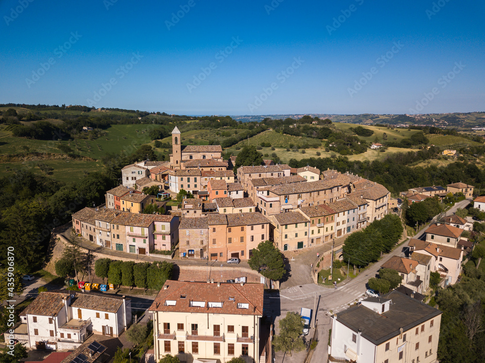 Italy, May 2021. Aerial view of the medieval village of Serrungarina in the province of Pesaro and Urbino in the Marche region. You can also see the green hills around.