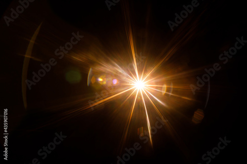 Fototapeta Naklejka Na Ścianę i Meble -  Easy to add lens flare effects for overlay designs or screen blending mode to make high-quality images. Abstract sun burst, digital flare, iridescent glare over black background.