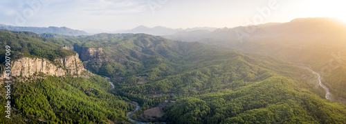 Morning landscape just after sunrise. The sun's rays fall on the mountain valley. Aerial view of Koprulu National Park near ancient city of Selge Adam Kayalar, Turkey. High resolution panorama