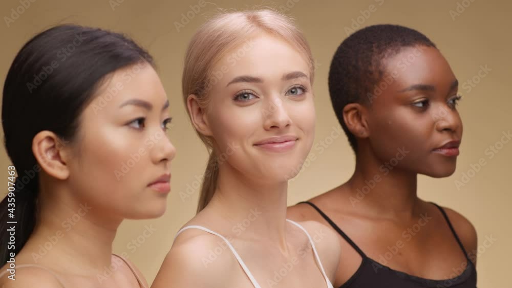 Young happy caucasian lady smiling to camera, posing with asian and african american friends, semi profile portrait Young happy caucasian lady smiling to camera, posing with asian and african american friends, semi profile portrait