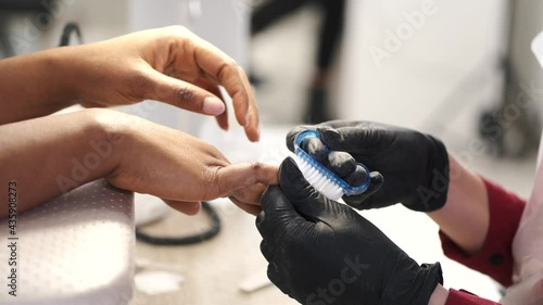 African girl doing manicure in a beauty salon photo