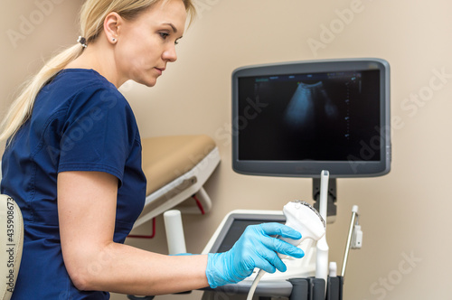 doctor makes an ultrasound to the patient in the clinic