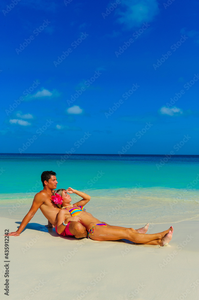 Couple at the beach, relaxing, sitting on the beach 