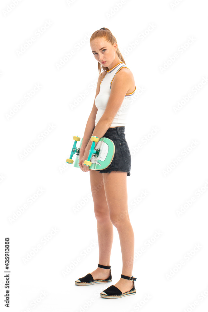 Red hair young model with skateboard in studio on white background Red hair young model with skateboard in studio on white background