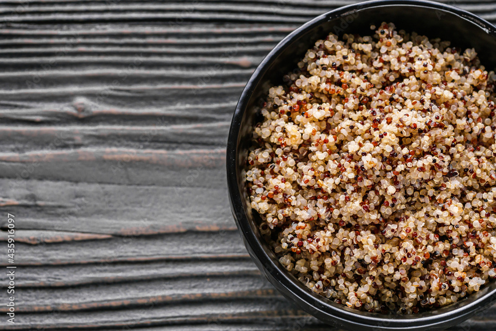 bowl of healthy quinoa on a dark wooden rustic background bowl of healthy quinoa on a dark wooden rustic background