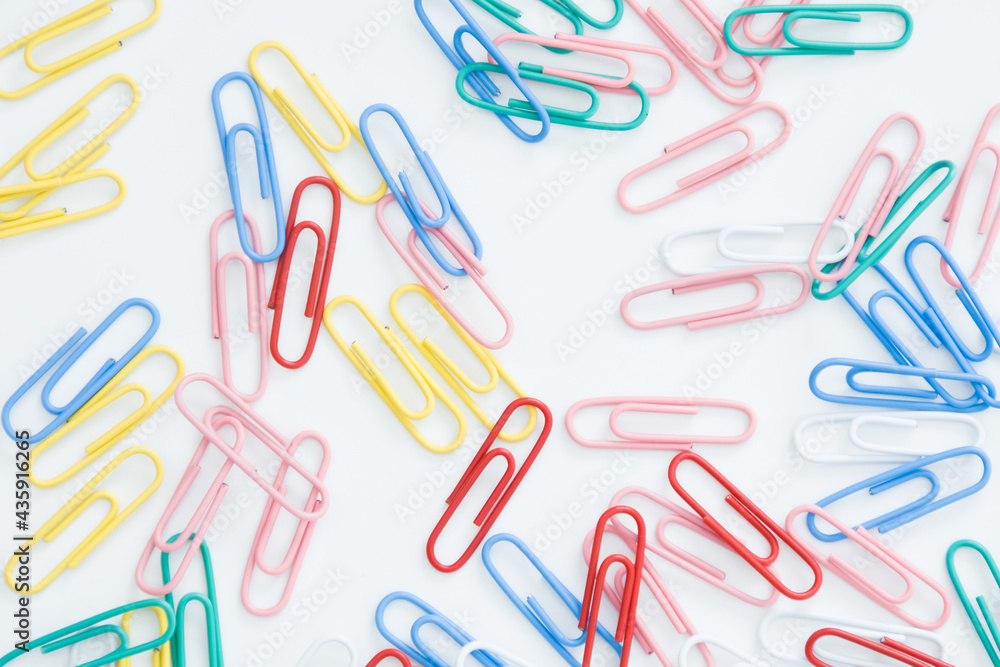 paper clips on a white background, scattered on the table paper clips on a white background, scattered on the table