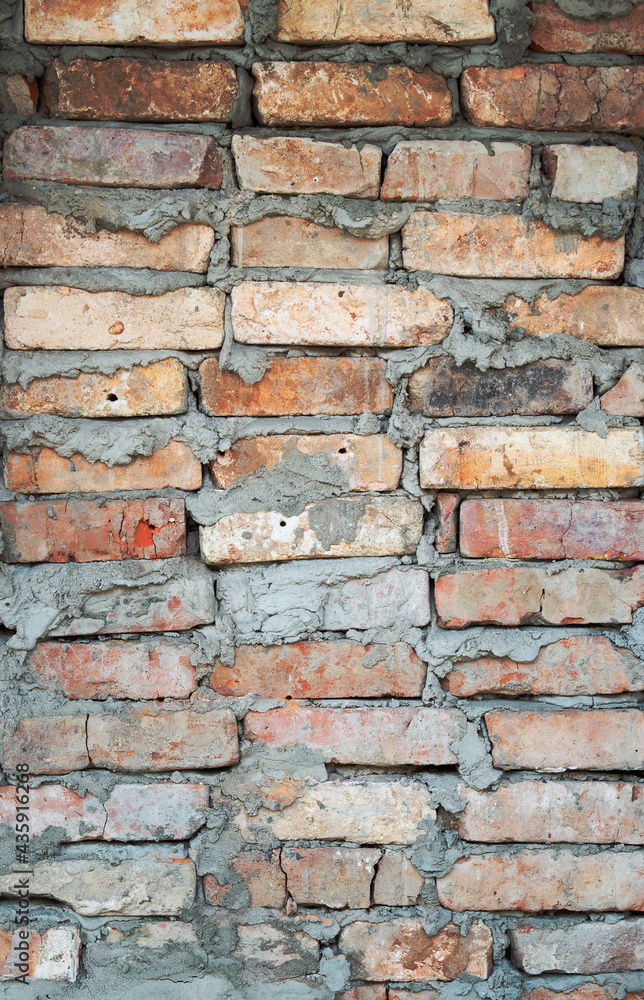 Old brick wall texture. The wall, made of old red bricks, darkened by old age. Ancient vintage background. Brick wall Old brick wall texture. The wall, made of old red bricks, darkened by old age. Ancient vintage background. Brick wall