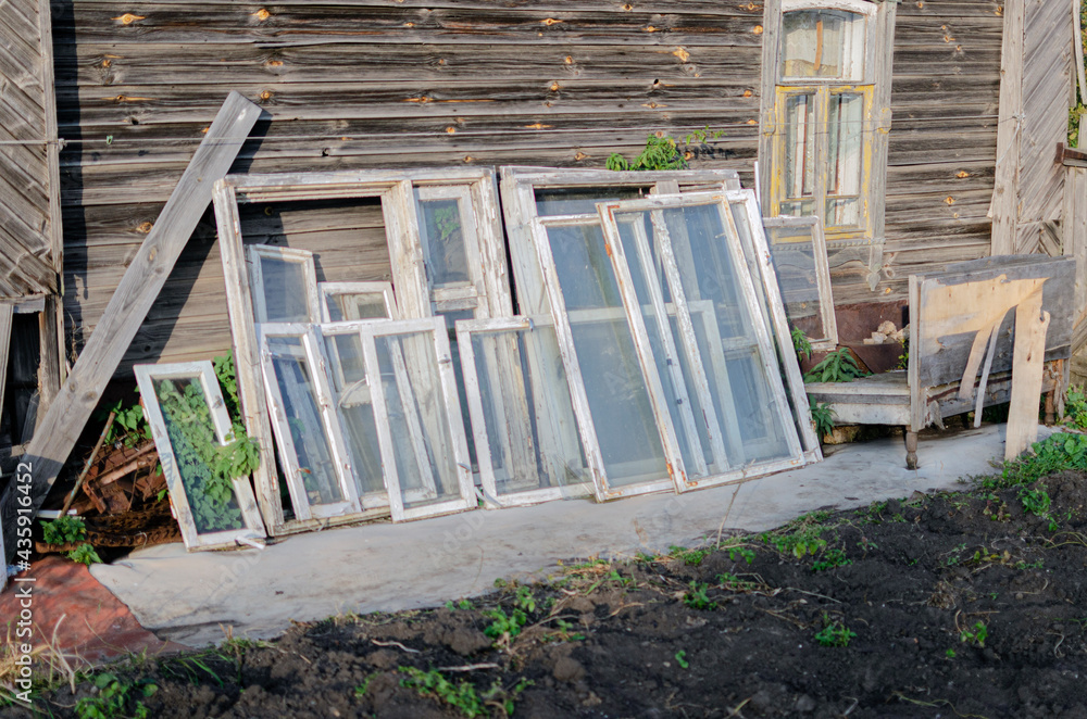 old window frames near a wooden house old window frames near a wooden house
