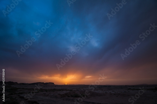 Colors of sunset with sun on horizon above landscape near Rissani in Morocco © marketanovakova