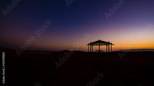Desert twilight with relax shadow chair with colorful sky