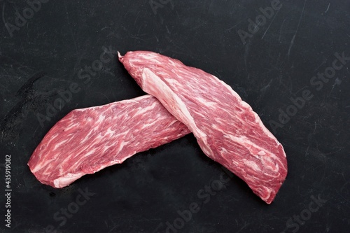 Machete Or Skirt Steaks Isolated on Black Background.  Raw Beef Steaks For Grilling Or Roasting Isolated on Black Background, Top View. Uncooked Tenderloin Machete Steaks or Bavet Steaks. photo