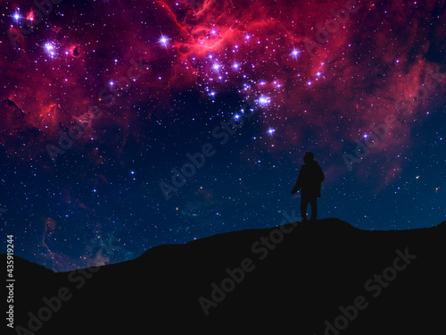 silhouette of a person standing on top of mountain and watch the sky galaxy. elements of this image furnished by nasa