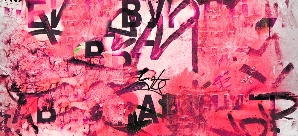 Obraz premium Artistic Urban Street Background with Grungy Wall with Ripped, Torn And Peeled Posters. Old Wall with Scratched Advertising. Old Billboard with Torn Posters. Vintage Wide Background and Texture.