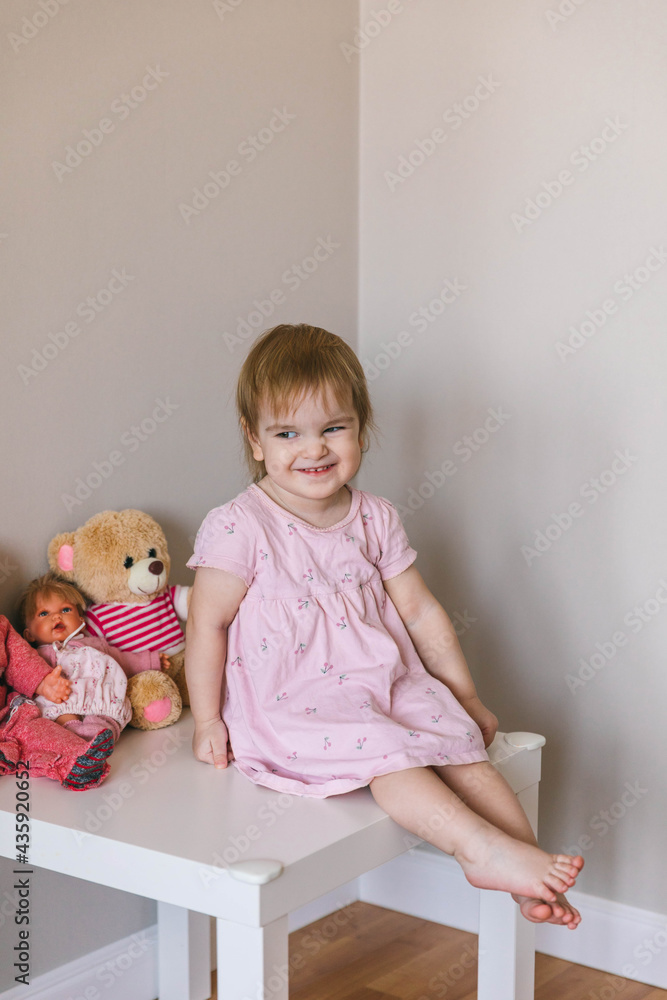 One and a half year old girl playing with a teddy bear. Taking care of children One and a half year old girl playing with a teddy bear. Taking care of children
