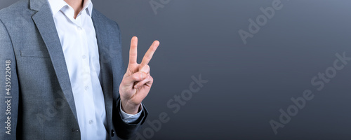 Portrait of a successful man showing victory sign