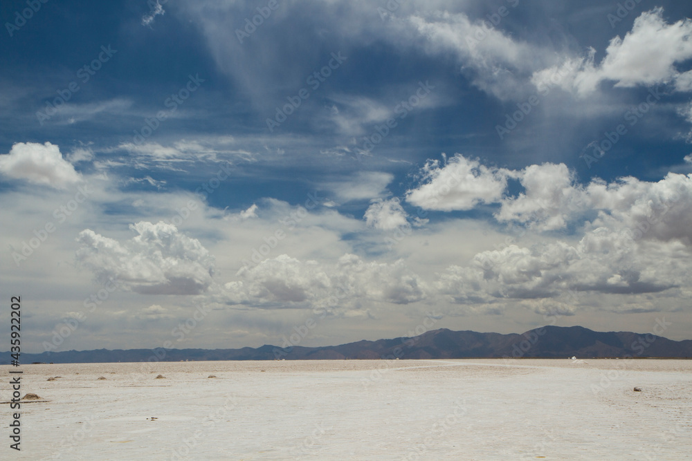 Fototapeta premium Industrial salt extraction opencast mining. View of the natural salt flat and salt mine under a beautiful sky in Salinas Grandes, Jujuy, Argentina.