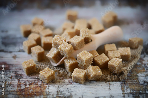 Macro. Selective focus. Brown sugar crystals cubes. photo