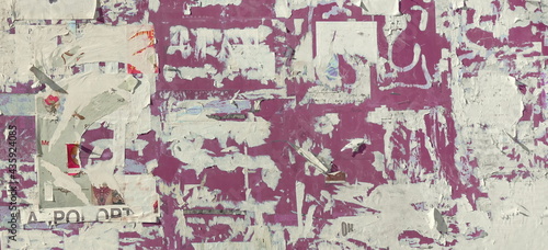 Grunge Wide Background with Old Torn Posters. Urban Graffiti Wall Texture. Grungy Ripped Wall with Torn Posters and Ads Background. Panoramic Urban Wallpaper. Graffiti Wall Texture. © Alex