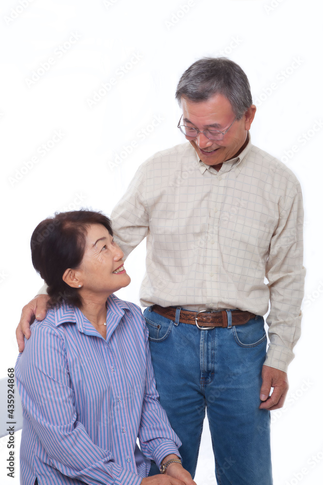Japanese senior couple smiling at the camera Japanese senior couple smiling at the camera