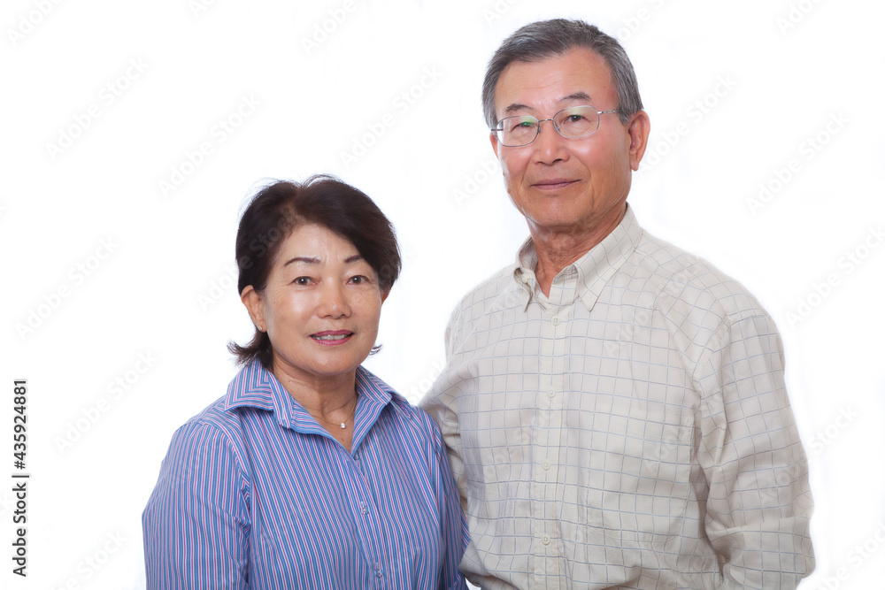 Japanese senior couple smiling at the camera Japanese senior couple smiling at the camera