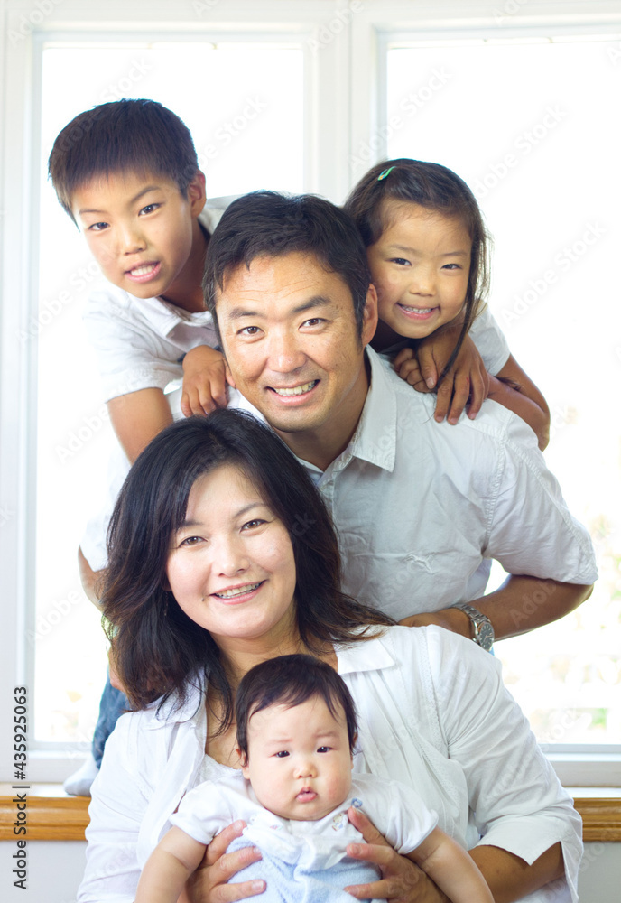 Japanese family smiling at the camera Japanese family smiling at the camera