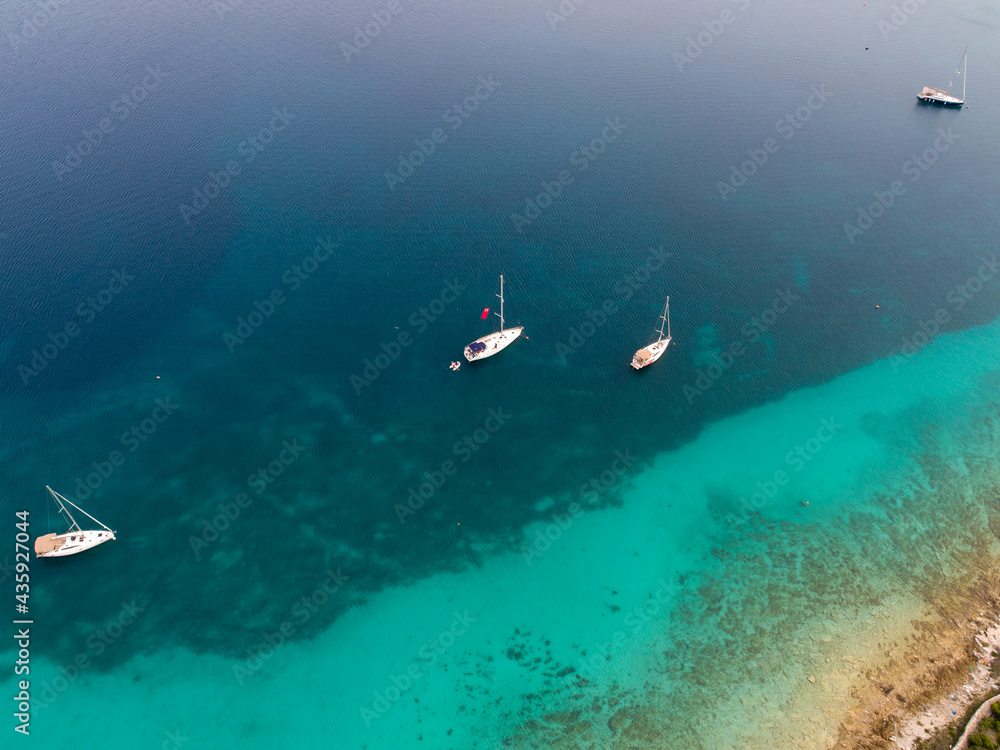 Croatian islands and sailing ships from drone view