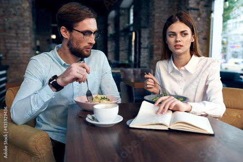 young couple in a cafe at the breakfast table communication lifestyle