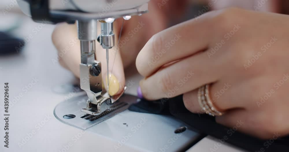 A woman, a clothing designer, cuts scissors in the workshop. A woman, a clothing designer, cuts scissors in the workshop.