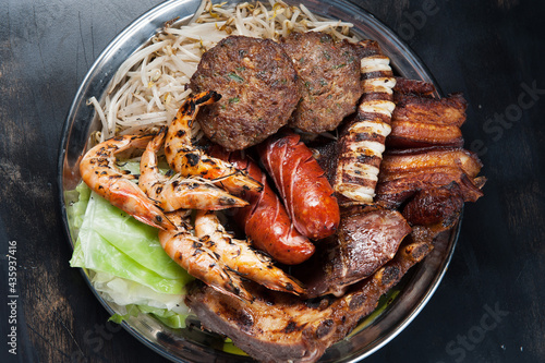 Asian food platter.  Grilled shrimp, beef patties, octopus, and pork belly.