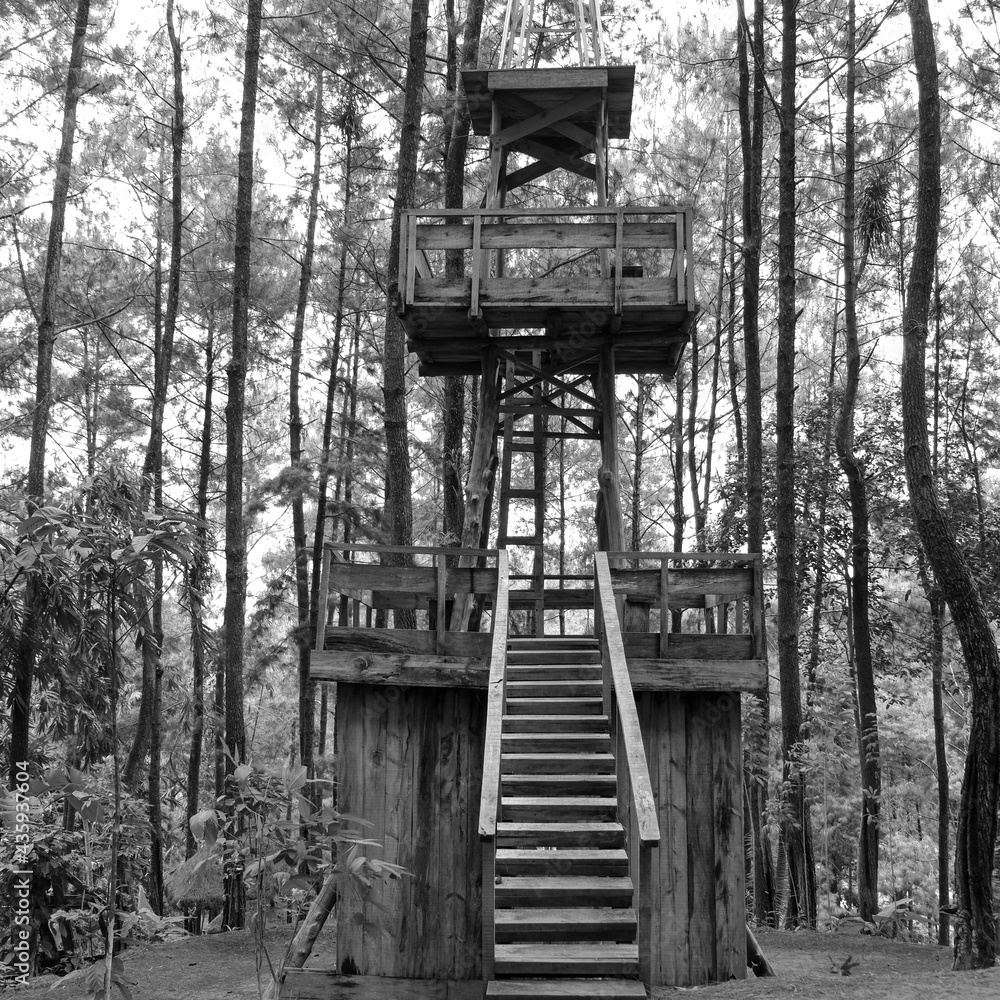 black and white photo of an artificial tower made of wood in a tourist spot in Indonesia