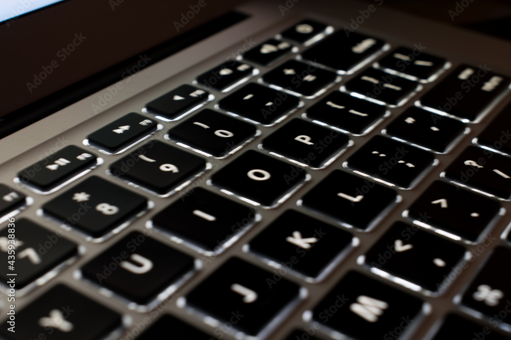 illuminated computer keyboard in the dark. selective focus illuminated computer keyboard in the dark. selective focus