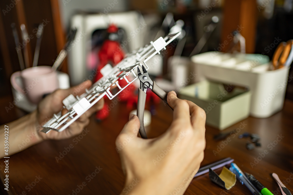 A man building a plastic model kit A man building a plastic model kit