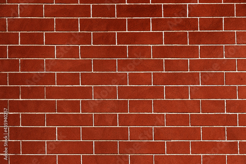 Brick wall is bright red, texture of stone blocks, background of bricks.
