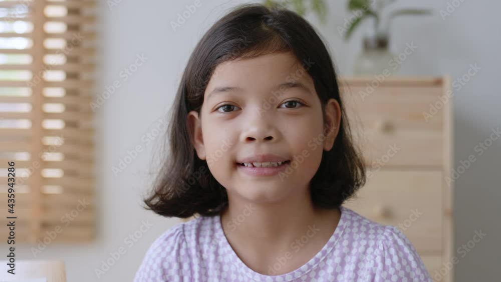 Happy Asian cute little girl smile on the face at home morning Happy Asian cute little girl smile on the face at home morning