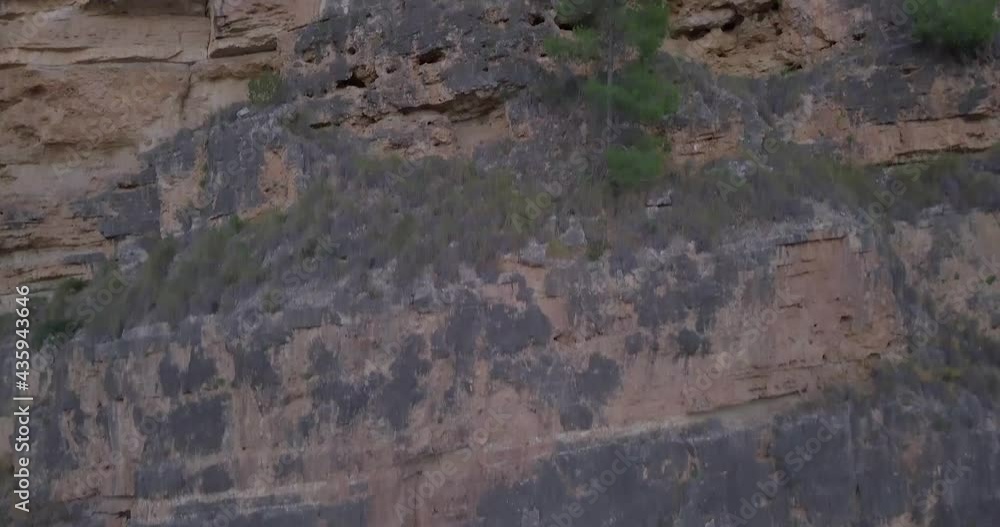 Drone soaring up the rocky hill from the mountains surrounding the river. Drone soaring up the rocky hill from the mountains surrounding the river.