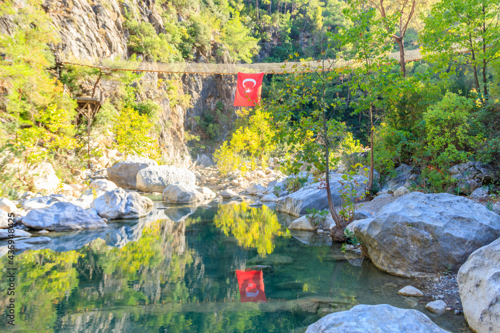 Turkish flag hanging from suspension wooden bridge in Goynuk canyon in Antalya province, Turkey